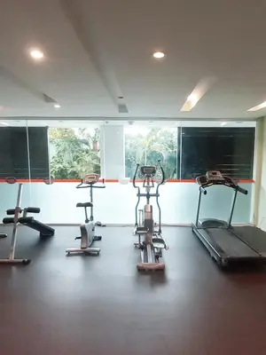 a gym with three exercise bikes in a room at Harris Hotel & Residences Kuta in Kuta