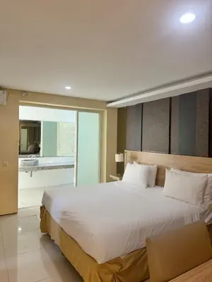 a bedroom with a large white bed and a balcony at 3 Bedroom Calla Villa in Nusa Dua