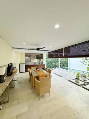 a kitchen and dining room with a table and chairs at 3 Bedroom Calla Villa in Nusa Dua