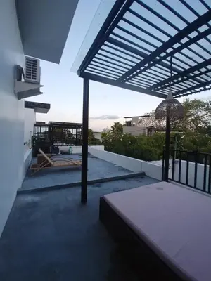 a patio with awning on the side of a house at 3 Bedroom Calla Villa in Nusa Dua