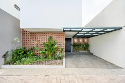 a facade of a building with a brick wall at Vinca Villa Bali in Kerobokan