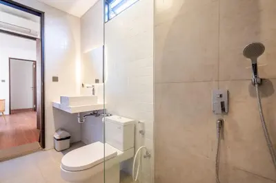 a bathroom with a shower with a toilet and a sink at Vinca Villa Bali in Kerobokan
