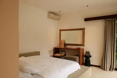 a bedroom with a bed and a desk and a mirror at Villa NUSA - 3BR Villa in Umalas next to Nook in Kerobokan