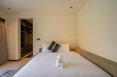 a white bed with a teddy bear sitting on it at Villa NUSA - 3BR Villa in Umalas next to Nook in Kerobokan