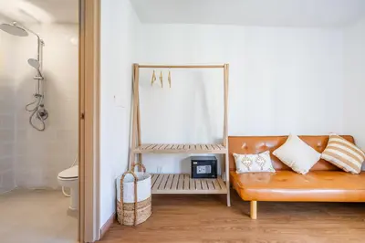 a dressing room with a mirror and a bench at IRMAS Villa Bali in Seminyak