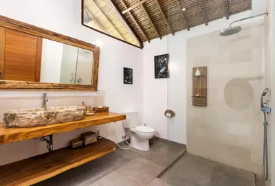 a bathroom with a sink and a toilet at Villa Waterlily by Villa Finder in Seminyak
