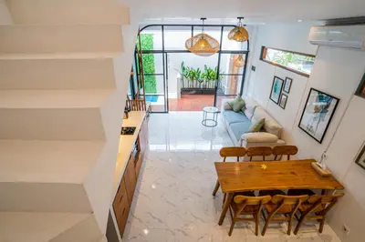 a kitchen and living room with a table and chairs at NEW! Villa Sony 1 - 3BR Villa next to Legian Beach in Seminyak