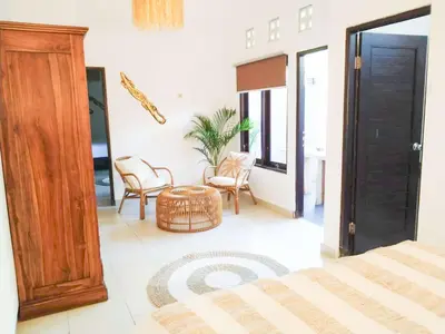 a bedroom with a bed and a table and chairs at Salt Hideaway - 2 BR apartment, central Seminyak in Seminyak