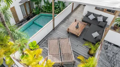 an overhead view of a balcony with a swimming pool at Villa Elita - Modern Stylish 4BR Villa with Rooftop Lounge, 12 Minutes to the Beach in Kerobokan