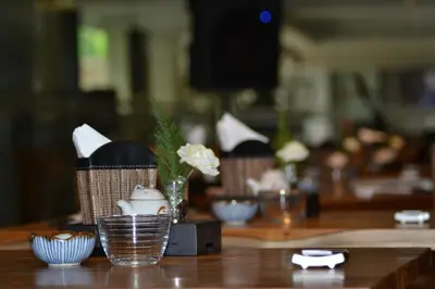 a table with bowls and vases on top of it at Sovereign Bali Hotel in Kuta