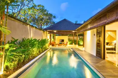 a swimming pool in the backyard of a house at Dilana 2 BR Bamboo Villas JU66 in Seminyak