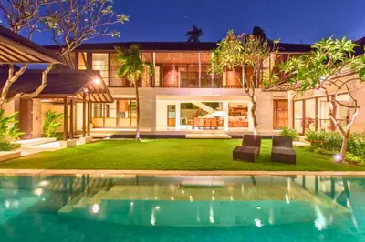 an exterior view of a house with a swimming pool at Neada 4 BR Grand Pool Villa JU68 in Seminyak