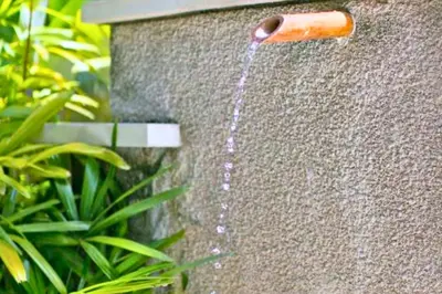 a water hose coming out of a stone wall at Neada 4 BR Grand Pool Villa JU68 in Seminyak