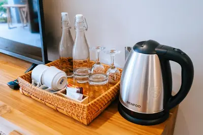 a basket with bottles and glasses on a table at Villa Koura Kuta in Kuta