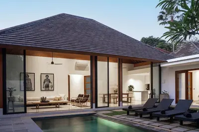 a villa with a swimming pool and a house at Villa Under the Sun - Seminyak in Seminyak
