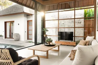 a living room with a large window and a tv at Villa Under the Sun - Seminyak in Seminyak
