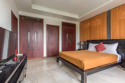 a bedroom with a bed and a flat screen tv at Quiet Central Seminyak 2bd 2 bath and walk to eat st in Seminyak