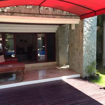 a house with a red roof and a patio at Quiet Central Seminyak 2bd 2 bath and walk to eat st in Seminyak
