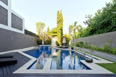 a swimming pool in the backyard of a house at Quiet Central Seminyak 2bd 2 bath and walk to eat st in Seminyak