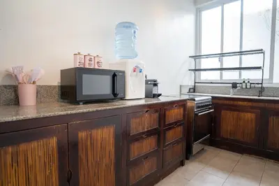 a kitchen with a counter with a microwave and a sink at Villa Catalina Seminyak in Seminyak