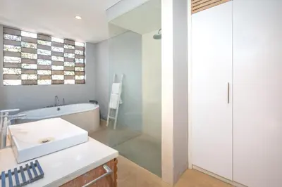 a bathroom with a tub and a sink and a shower at Villa Ewa 1 in Seminyak