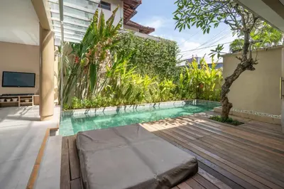 a swimming pool in the middle of a house at Villa Ewa 1 in Seminyak