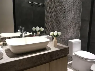 a bathroom with a sink and a toilet at Modern Palace in Seminyak - Qmoya Villa in Seminyak