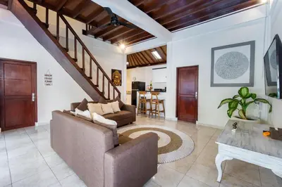 a living room with a couch and a table at Villa Simara in Seminyak