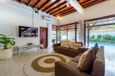 a living room with a couch and a table at Villa Simara in Seminyak