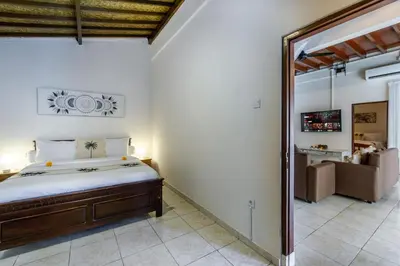 a bedroom with a bed and a mirror at Villa Simara in Seminyak