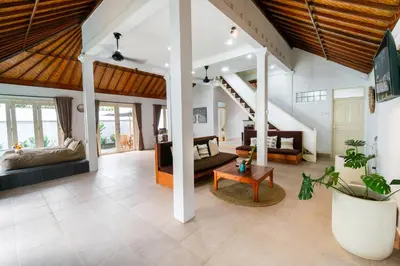 a living room with a couch and a table at Villa Putri Mila in Seminyak