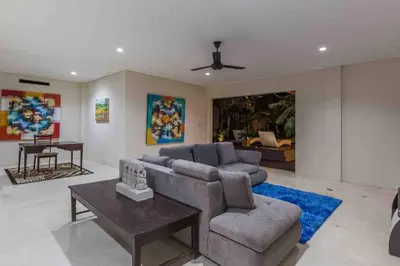 a living room with a couch and a table at Big 3 bed, to BatuBelig Beach, last min specials in Kerobokan