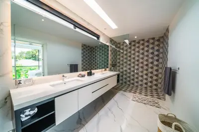 a bathroom with two sinks and a large mirror at Villa Blue Water by GORO in Seminyak