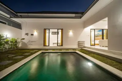 a swimming pool in the middle of a house at Villa Semangka, Seminyak Umalas in Kerobokan