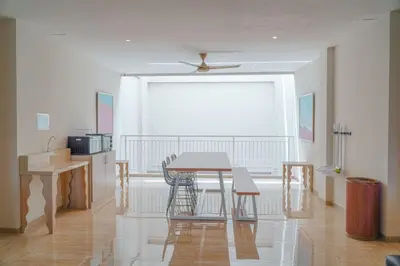 a dining room with a table and chairs and a window at Bali Bustle Pararaton Coliving and Coworking Space in Legian