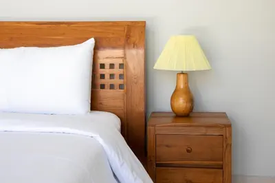 a bedroom with a bed and a lamp on a night stand at Letto 1 - Luxurious Villa with Pool in Canggu in Canggu