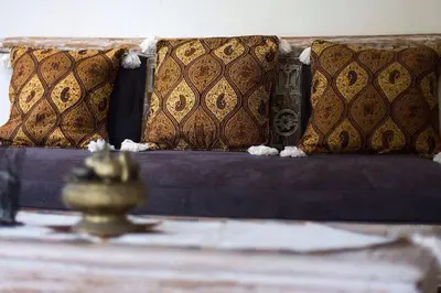 a bed with pillows on it with a table with at Villa Chandra in Seminyak