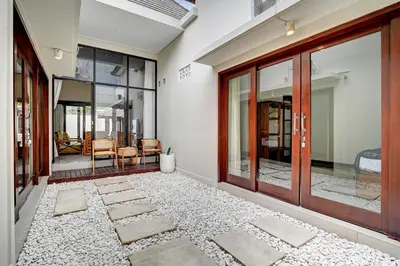 an open hallway with glass doors and a rug at Villa bella wilson II in Seminyak