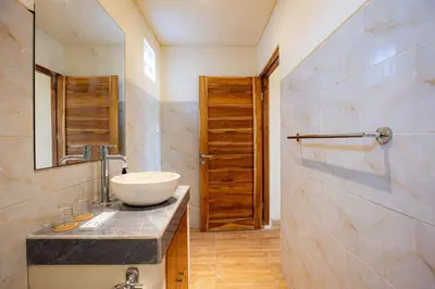 a bathroom with a sink and a mirror at Cove Lotus Lofts Seminyak in Seminyak