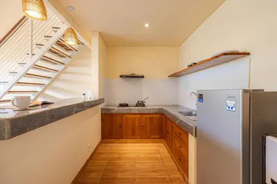 a kitchen with a sink and a refrigerator at Cove Lotus Lofts Seminyak in Seminyak