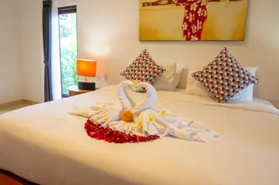 a bed with two swans made out of towels at VIlla Dafne in Seminyak