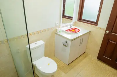 a bathroom with a toilet and a sink at VIlla Dafne in Seminyak