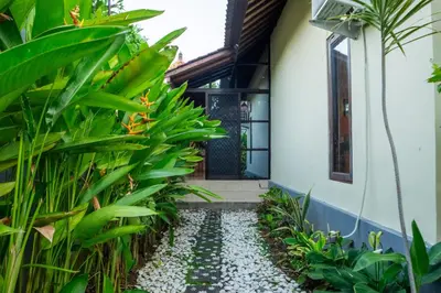 a walkway leading to the front door of a house at VIlla Dafne in Seminyak