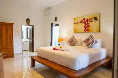 a bedroom with a large white bed in a room at VIlla Dafne in Seminyak