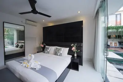 a bedroom with two beds and a large window at 7to8BR 40 off special Brilliant Location in Seminyak