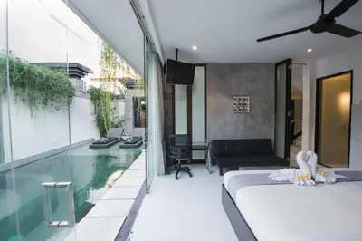 a bedroom with a bed and a swimming pool at 7to8BR 40 off special Brilliant Location in Seminyak