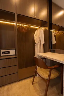 a walk in closet with a table and a chair at Nococu Luxury Villa in Seminyak