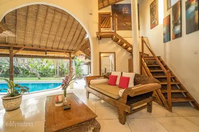 a living room with a couch and stairs and a pool at Tropical 3BR villa in the heart of Seminyak in Seminyak