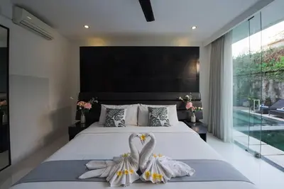 a bedroom with a large bed with flowers on it at 20 off Special Brilliant Location in Seminyak