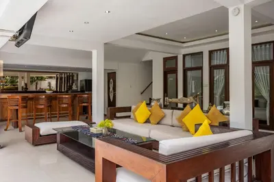 a living room with a couch with yellow pillows at 3 BR Villa in d' centre Seminyak in Seminyak